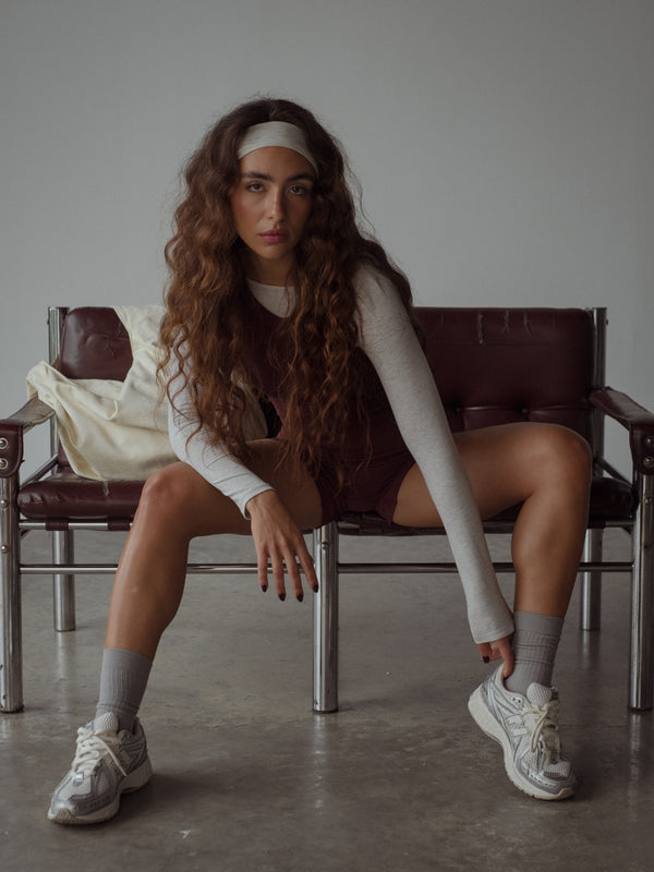 Modelo usando set deportivo color vino y medias color gris.