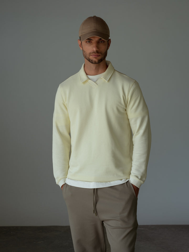 CAMIBUZO, COLOR CREMA, CUELLO CAMISERO,  PERILLA DEL CUELLO EN TEJIDO Y PUÑOS. 