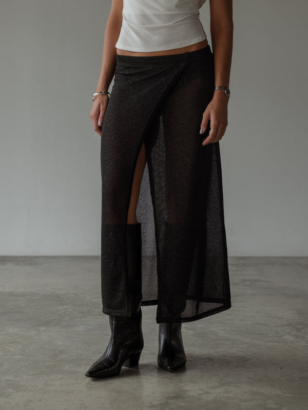 Vista frontal de falda negra con transparencia y brillos. 