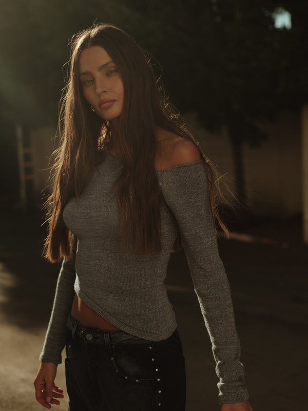 Modelo usando top tejido manga larga gris con jean gris doble lavado.